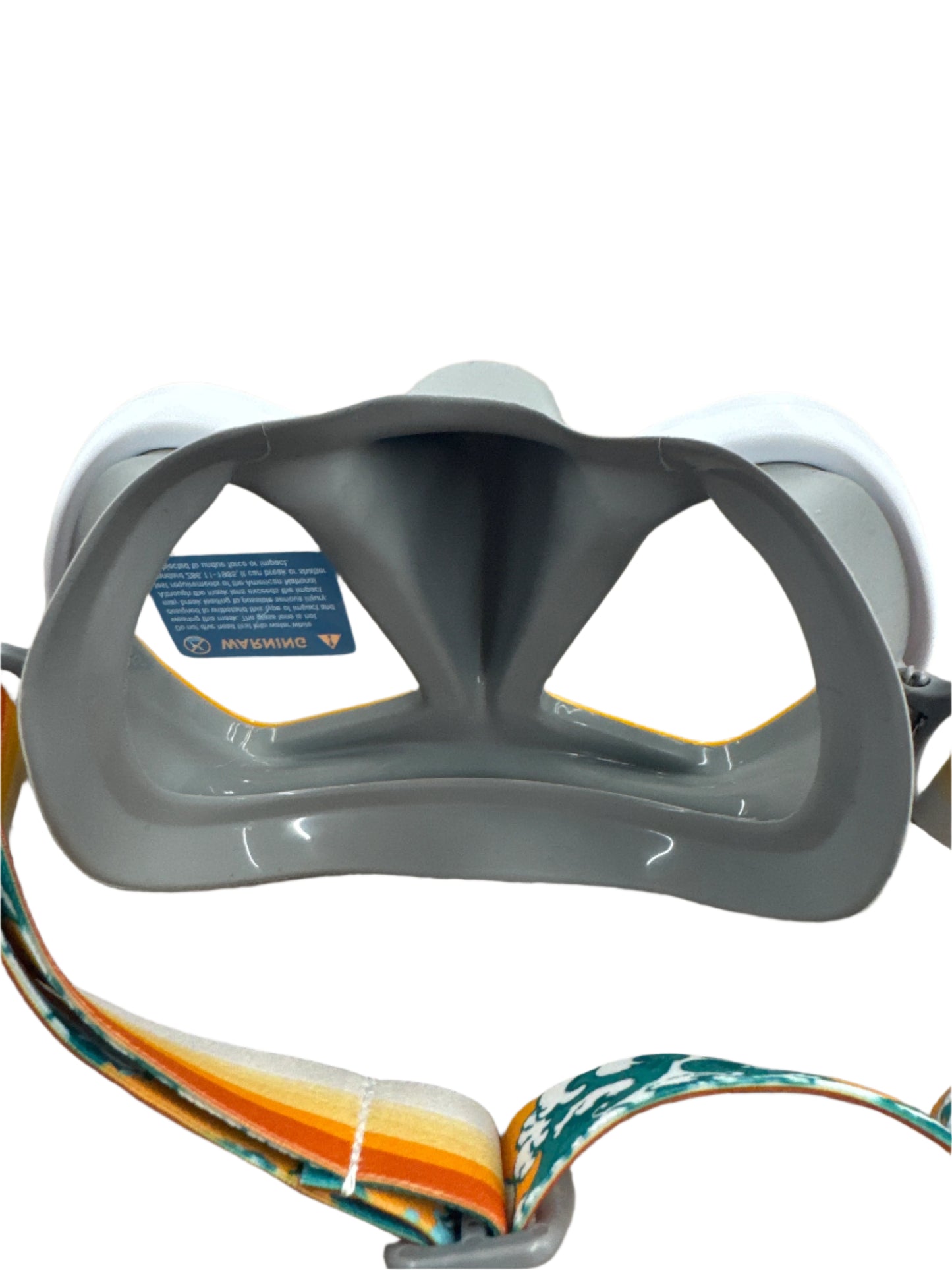 Gray snorkel mask with a colorful strap on a car seat